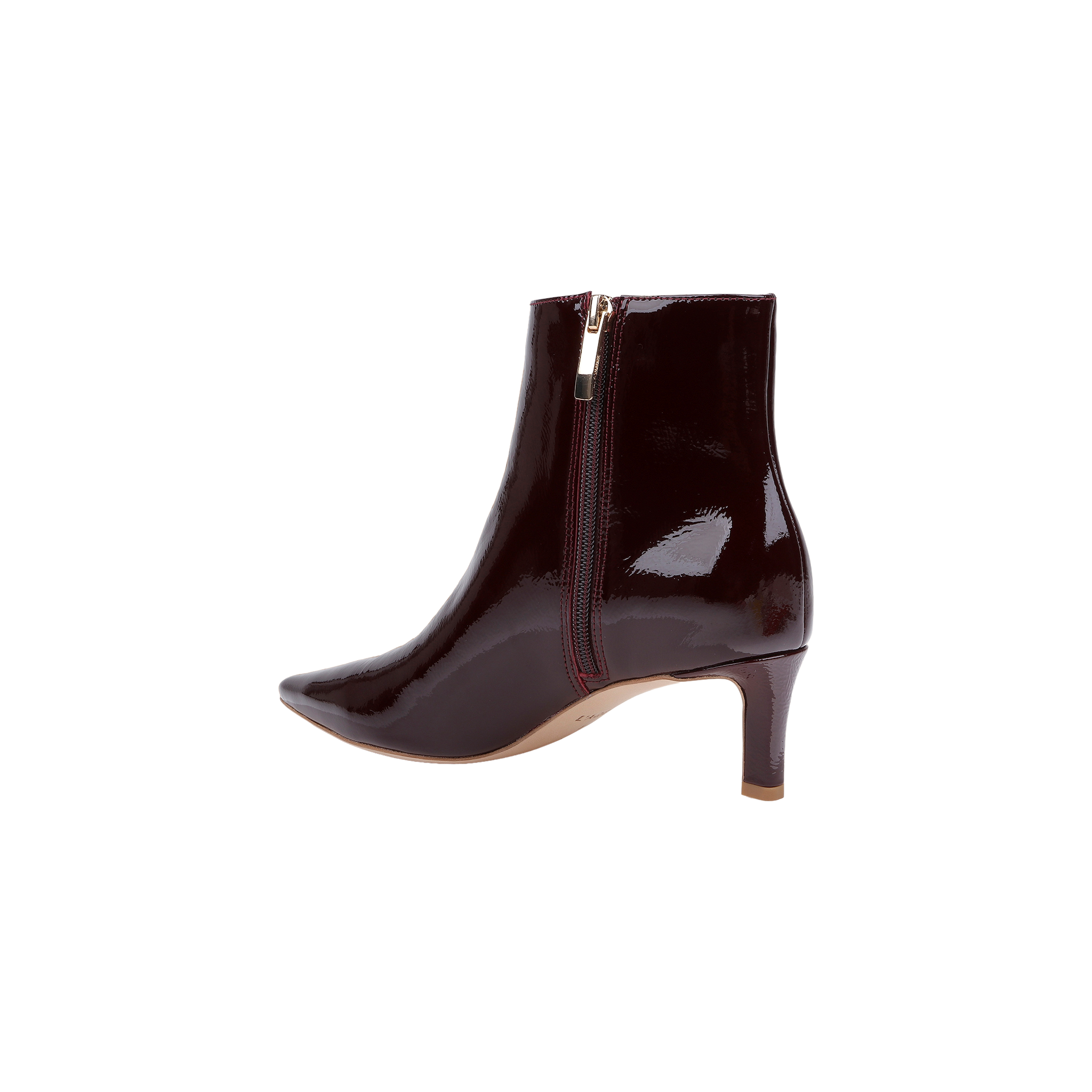 The Lilly Kitten-Heel Bootie is crafted from shiny dark burgundy patent leather and features a pointed toe, side zipper, and mid-height kitten heel, shown on a plain white background.