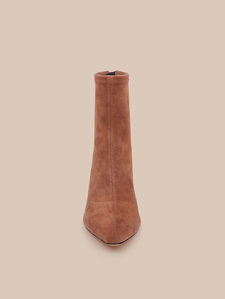 The Salome Stretch Suede Boot is displayed from the front, showcasing its chic block heel and tan suede finish against a simple beige background.
