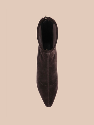 A single Salome Stretch Suede Boot in dark brown, viewed from above against a light beige background, highlighting its pointed toe and visible stitching.