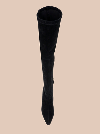 The Clarin Over-the-Knee Boot is displayed from a top-down angle against a plain beige background, featuring a single black suede design with a pointed toe and a subtle flared heel.