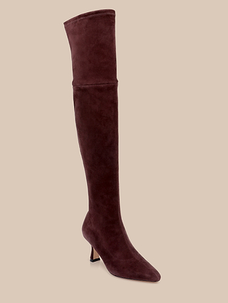 The Clarin Over-the-Knee Boot, crafted in rich mahogany brown suede with a pointed toe and a low, slim heel, is displayed against a light beige background.