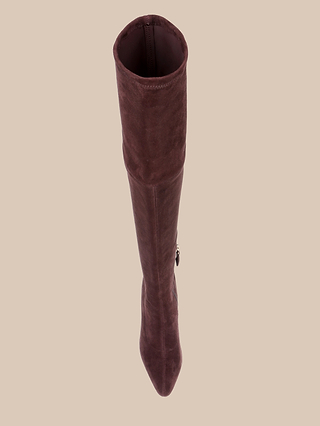 The Clarin Over-the-Knee Boot, shown in a single tall mahogany brown design with a pointed toe and side zipper detail, is displayed from above on a beige background.