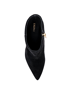 Top view of a single Sylvie Suede Bootie by L'AGENCE in black suede, featuring a gold side zipper and visible brand label inside, set against a white background.