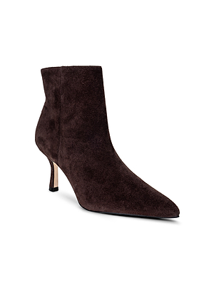 The L'AGENCE Sylvie Suede Bootie features dark brown suede, a pointed toe, and a short, slender heel. Displayed on a white background.