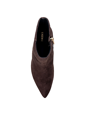 Top view of a dark brown suede Sylvie Bootie with a pointed toe, side zipper, and L'AGENCE branding on the black insole, isolated on a white background.