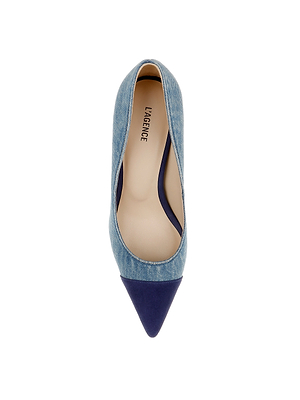 The Kendelle Denim Pump is a pointed-toe classic in blue denim with a navy suede cap toe, shown from above on a white background. The insole features the L’AGENCE logo.