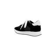 The Deepa Platform Sneaker, shown from a side angle on a plain white background, features black and white coloring with white laces, a thick white sole, a black suede finish, and a comfortable memory foam insole.