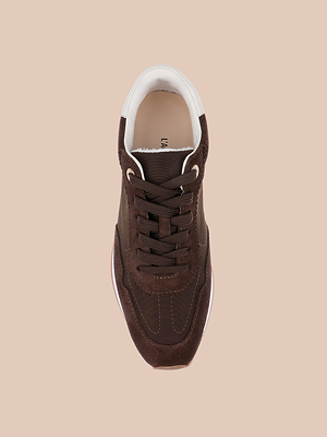 A top-down view of the Deepa Platform Sneaker in chocolate suede, featuring dark brown laces, a white collar, beige sole, and cushioned memory foam insole, set against a plain light beige background.