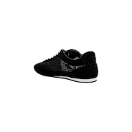 The Jarah Sneaker features black suede uppers with a shiny, textured side panel, complemented by a white sole and white shoelaces. Designed for comfort, it includes a memory foam insole. The shoes are displayed at an angle on a plain white background.
