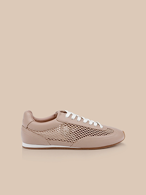 The Jarah Sneaker, a tan leather shoe with white laces and side mesh panels, is shown against a beige background for a subtle retro-inspired style.