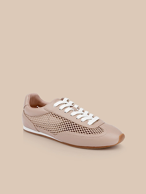 The Jarah Sneaker is a retro-inspired beige shoe featuring white laces, mesh side panels, and a light brown rubber sole, displayed on a matching beige background.