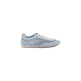 The Jarah Sneaker is a light blue retro-inspired shoe featuring white laces, light blue suede accents, and a mesh side panel. It sits atop a brown sole and is presented against a plain white background.
