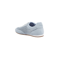 The Jarah Sneaker showcases a retro-inspired design with light blue suede, white laces, a mesh side panel, and a brown sole. Pictured from the back at an angle, the sneaker features the brand name subtly displayed on the heel.