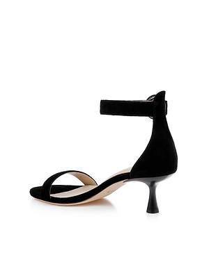 The Andelle Kitten-Heel Sandal is a black suede, open-toe sandal with a low kitten heel, front strap, ankle buckle strap, and cushioned memory foam insole for comfort. Shown on a white background.