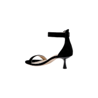The Andelle Kitten-Heel Sandal in black suede showcases an open toe, a low curved kitten heel, and an ankle strap fastening, complemented by a memory foam insole. Shot in side profile against a plain white background.