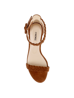 The Andelle Kitten-Heel Sandal is a brown woven suede sandal featuring braided straps, an ankle buckle, and an open toe. It is shown top-down on a white background with 