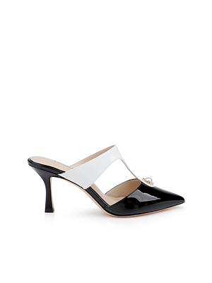 The Bayonne Mule is a black and white leather shoe with a pointed toe, open back, mid-height heel, and a pearl-accented strap. Shown against a white background.