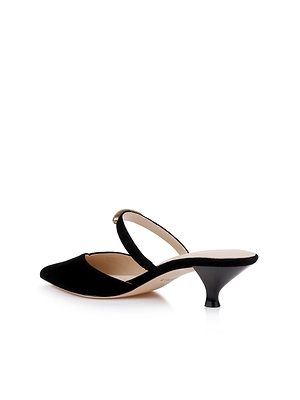 The Catania Kitten-Heel Pump is a black mule with a pointed toe, suede upper, low kitten heel, and a single arched strap across the instep, shown on a white background.