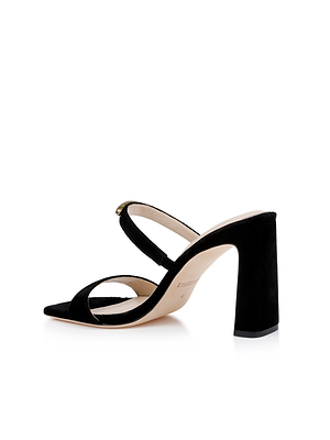 The Catriona Suede Sandal is a black mule with two slim straps, a suede upper, pointed toe, and chunky block heel, shown on a white background.