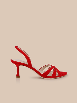 The Colwill Slingback Sandal features a red suede upper, open toe, low heel, crisscross toe straps, and an adjustable slingback strap, shown against a neutral beige background.