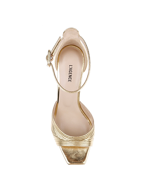 A top view of the Cici Stiletto Sandal shows a gold, open-toe high heel with a square toe, pleated metallic Nappa leather strap, ankle strap with buckle, and LAGENCE branding on the insole.