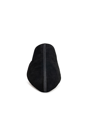 The Como Slipper is a black suede mule shown from the back, highlighting a vertical center seam. It features a memory foam insole and is photographed on a plain white background for a minimalist look.