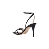 The Dua Leather Sandal features a strappy black patent leather design with thin straps across the toes and a buckled ankle strap, shown in a side view against a white background.