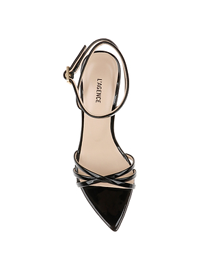 Top view of the Dua Leather Sandal in black patent leather, featuring a stiletto heel, thin ankle and toe straps with a gold buckle, and L’AGENCE labeled on the insole, set against a white background.