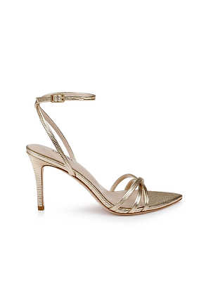 The Dua Leather Sandal is a gold leather sandal with lizard embossing, thin toe and ankle straps, pointed toe, stiletto heel, buckle closure, and textured finish, shown against a white background.