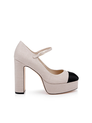 The Lilles Platform Pump is a beige Mary Jane with a thick block heel, single buckle strap, and contrasting black rounded toe cap, shown on a white background.