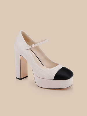 The Lilles Platform Pump, a beige Mary Jane style with a black toe cap, buckle strap, and block heel, is displayed against a plain light tan background.