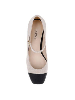 Top view of the Lilles Platform Pump, a beige Mary Jane with a black square toe cap, single strap with gold buckle, and L’AGENCE branding on the insole.