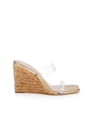 The Farrell Wedge Espadrille features a single braided raffia wedge, beige footbed, gold leather trim, and two clear plastic straps, shown against a white background.