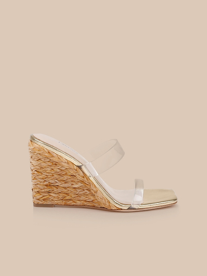 The Farrell Wedge Espadrille features a woven straw heel, clear straps, and a light sole, shown individually against a neutral beige background.