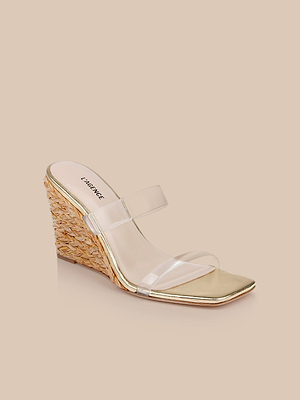The Farrell Wedge Espadrille features a raffia wedge heel, gold leather footbed, and two clear straps across the foot, shown on a neutral beige background—ideal for those who love stylish clear vamp sandals.