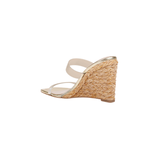 Farrell Wedge Espadrille featuring a beige braided raffia wedge heel, clear toe strap, and nude ankle strap, shown in a side view against a plain white background.