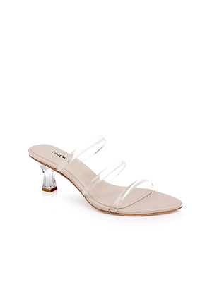 The Ludovica Kitten-Heel Sandal is a beige minimalist mule with a low, clear acrylic heel and three transparent vinyl bands, shown on a white background.