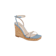 The Malone Wedge Espadrille is a bohemian-style wedge sandal showcasing a woven raffia heel, light blue fabric across the toe, clear straps over the foot, and a light ankle strap with buckle closure. Its cushioned beige insole provides comfort and is finished with a brand label.