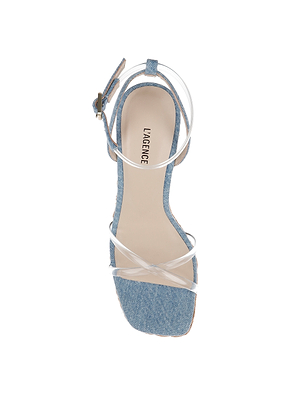 The Malone Wedge Espadrille features a denim-textured sole, clear crisscross straps, and an ankle buckle. LA AGENCE is printed on the insole, shown from above against a white background for a modern update on classic style.
