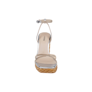 Front view of the Malone Wedge Espadrille, featuring a clear ankle strap, metallic silver footbed, and a braided raffia wedge platform sole. Ideal for those looking for chic silver sandals with an espadrille-inspired design.