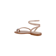 The Mariana Suede Sandal, crafted in tan suede with asymmetric straps, features a delicate ankle strap and minimalist toe loop, set on a light brown sole against a plain white background.