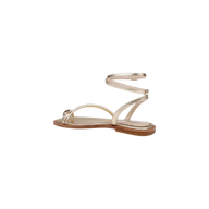 Mariana Leather Sandal in gold lizard-embossed leather, featuring a metallic finish with a slender toe strap and wraparound ankle tie, tan sole, photographed on a plain white background.