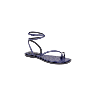 Introducing the Mariana Leather Sandal: a single flat sandal crafted in shiny purple crocodile-embossed leather, featuring thin ankle ties, a toe loop, and a silver accent at the toe.