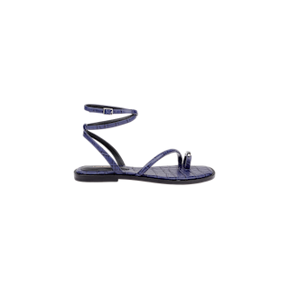 The Mariana Leather Sandal is a purple leather sandal featuring a textured, crocodile-like pattern, flat sole, toe loop, and thin ankle strap with buckle, shown in profile on a white background.