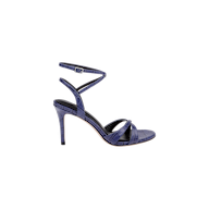 The Miranda Leather Sandal is a single high-heeled shoe in textured navy leather, featuring a thin ankle-wrap strap with buckle and crisscross straps over the open toe, displayed against a white background.