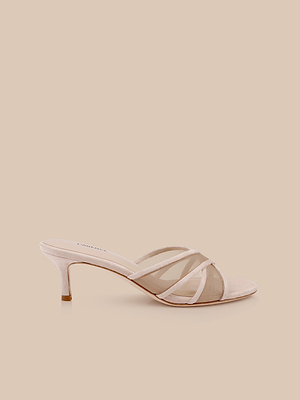 The Padua Mesh Sandal is a light pink suede mule with crisscross straps, an open toe, mid-height thin heel, and memory foam insole, shown against a beige background.