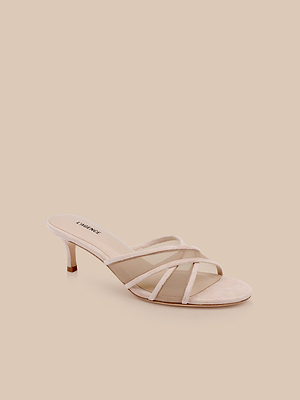The Padua Mesh Sandal: a single beige open-toe suede mule with thin crisscross straps, short heel, and memory foam insole, displayed on a solid beige background.