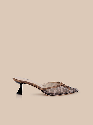 The Palermo Mesh Mule is a pointed-toe shoe featuring a brown and black leopard print mesh upper, a small decorative bow, and a short sculpted heel, shown against a neutral beige background.