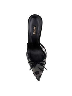 The Prasad Mesh Mule is a black pointed-toe mule with floral and butterfly embroidery, a small front bow, and L’AGENCE in gold on the insole, shown from above on a white background.