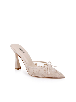 The Prasad Mesh Mule is an elegant light beige mesh mule featuring butterfly embroidery, a pointed toe, and a small front bow, shown against a white background.